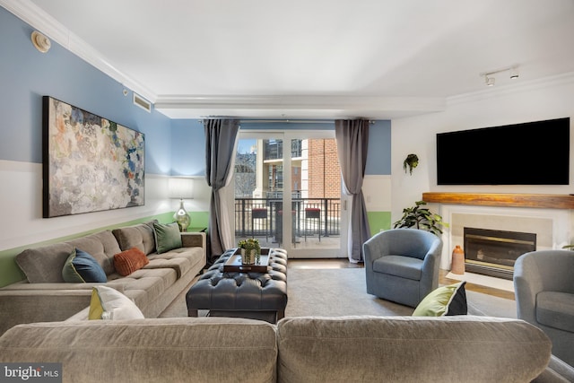 living room with rail lighting and crown molding