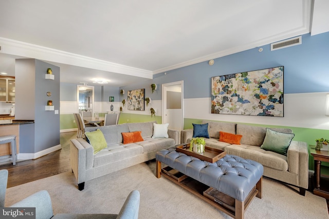 living room featuring ornamental molding and wood-type flooring