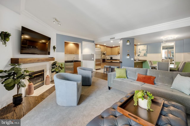 living room featuring wine cooler, light colored carpet, and crown molding