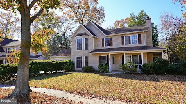 view of front facade with a porch and a front lawn