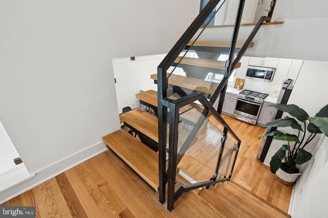 staircase with wood-type flooring