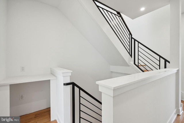 stairs featuring hardwood / wood-style floors