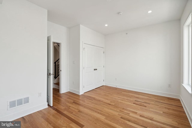 spare room with light hardwood / wood-style floors