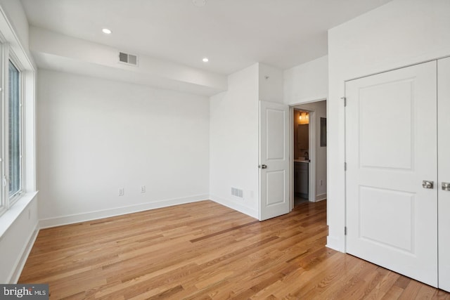 unfurnished room featuring plenty of natural light and light hardwood / wood-style flooring