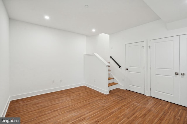 basement with hardwood / wood-style flooring