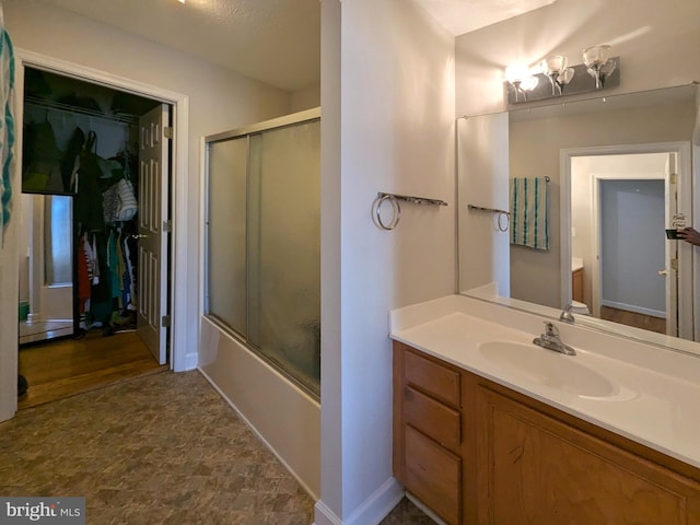 bathroom with vanity and enclosed tub / shower combo