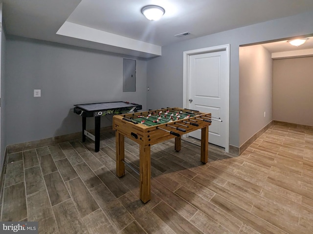 rec room with wood-type flooring and electric panel