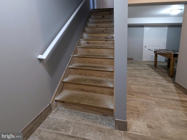 stairs featuring hardwood / wood-style floors