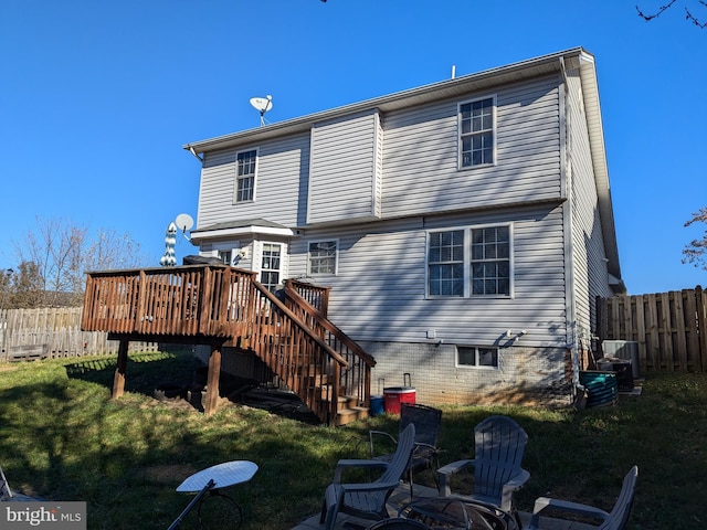 back of property with central AC unit, a yard, and a wooden deck