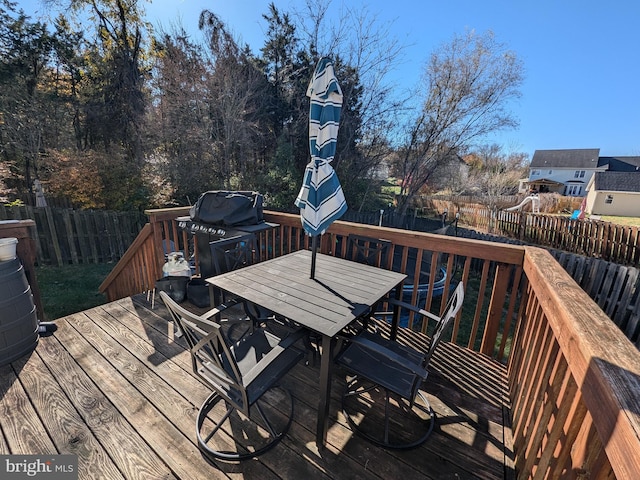 wooden terrace featuring area for grilling