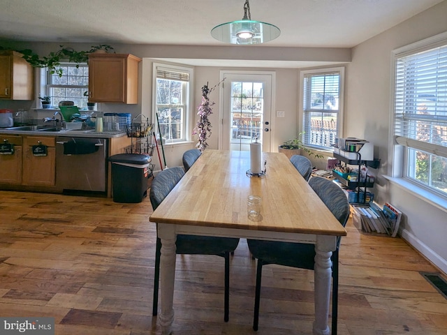 dining space with dark hardwood / wood-style floors and sink