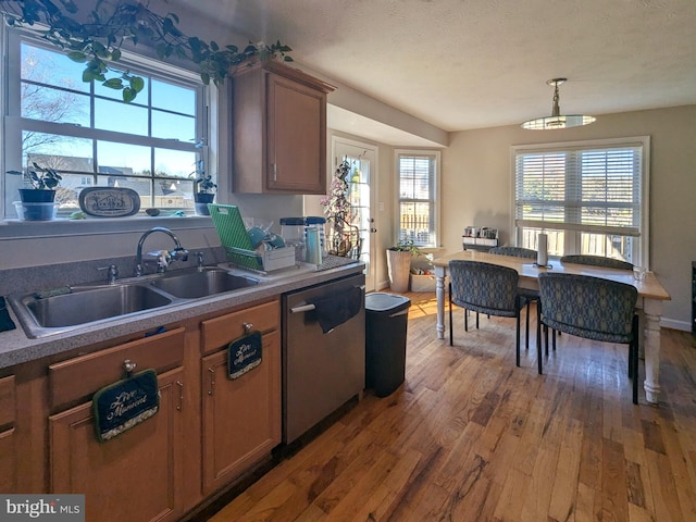 kitchen with dark hardwood / wood-style flooring, a textured ceiling, sink, pendant lighting, and dishwasher