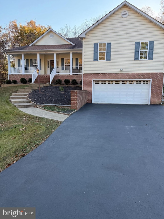 view of front facade featuring covered porch and a garage