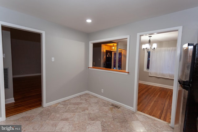 interior space with a chandelier and light hardwood / wood-style flooring