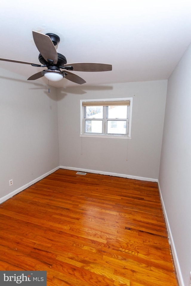 spare room with hardwood / wood-style floors and ceiling fan