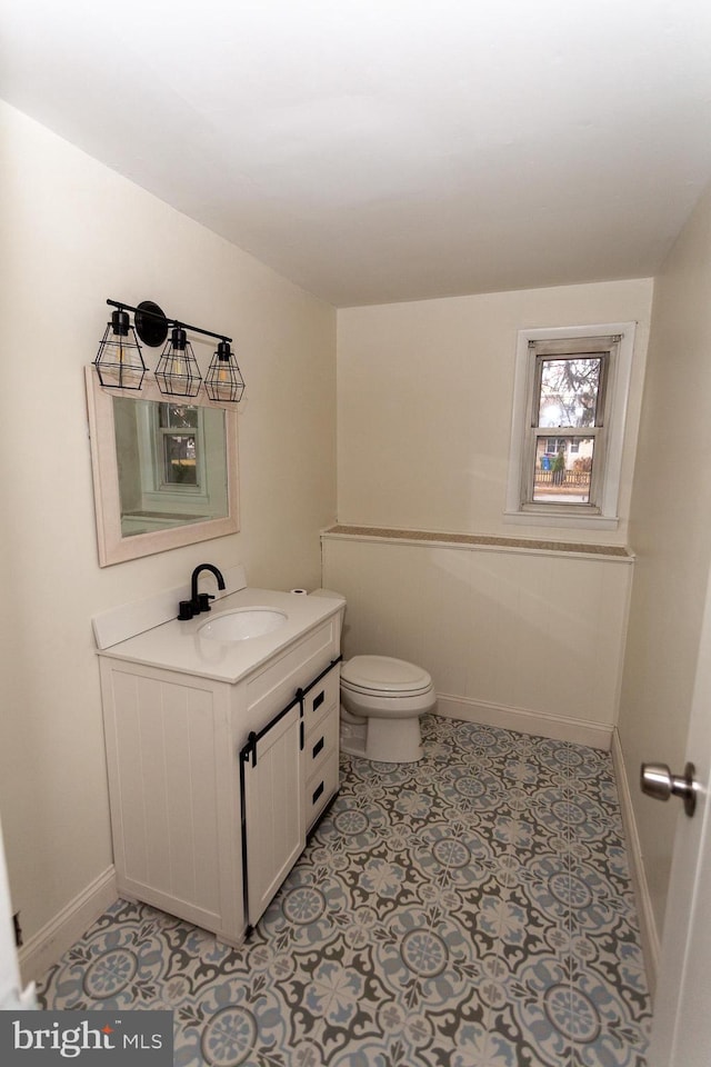 bathroom featuring vanity and toilet