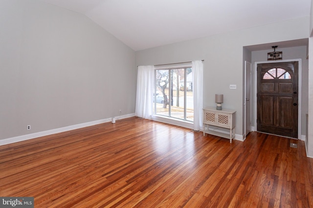 foyer entrance featuring dark hardwood / wood-style floors, an inviting chandelier, and lofted ceiling