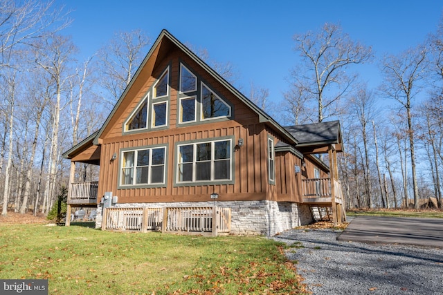 view of side of property featuring a yard and a porch