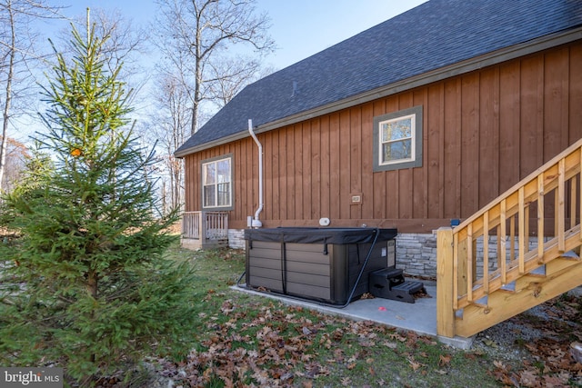 view of side of property with a hot tub