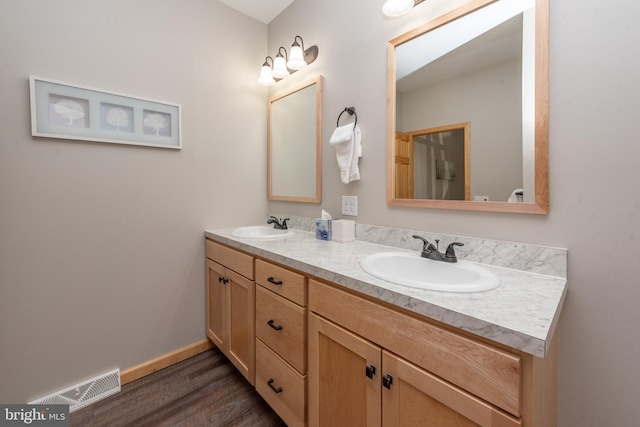 bathroom featuring vanity and hardwood / wood-style flooring