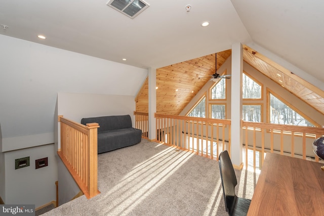 carpeted home office with ceiling fan and vaulted ceiling