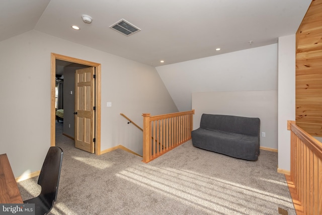 sitting room with lofted ceiling and carpet floors