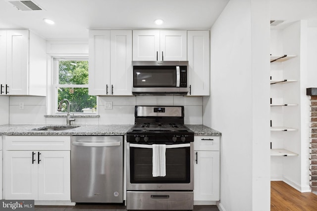 kitchen featuring white cabinetry, appliances with stainless steel finishes, and sink