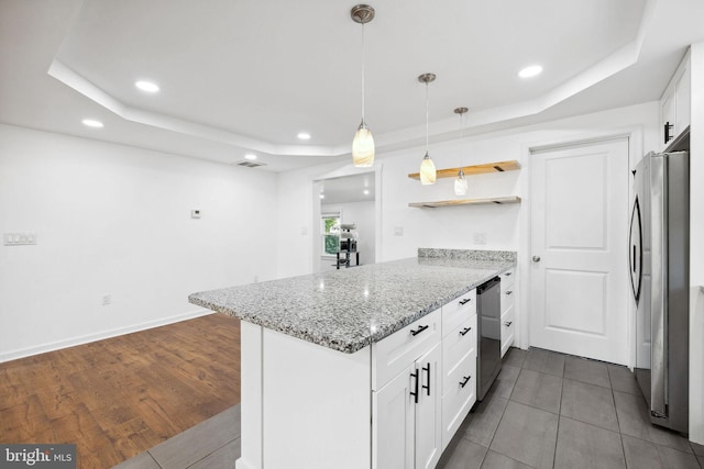 kitchen featuring white cabinetry, kitchen peninsula, appliances with stainless steel finishes, dark hardwood / wood-style floors, and a tray ceiling