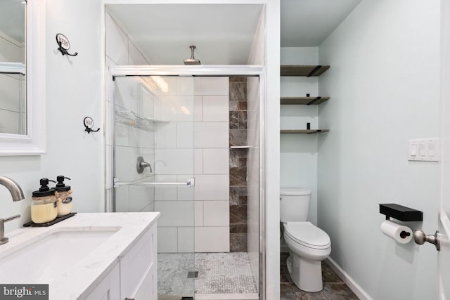 bathroom featuring walk in shower, vanity, and toilet