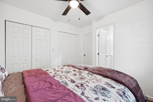 bedroom featuring multiple closets and ceiling fan