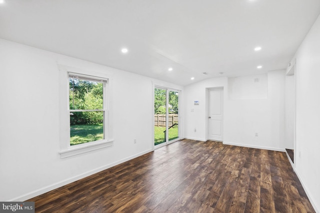 unfurnished room featuring dark wood-type flooring, lofted ceiling, and plenty of natural light