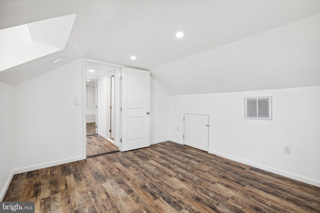 bonus room with dark hardwood / wood-style floors and vaulted ceiling