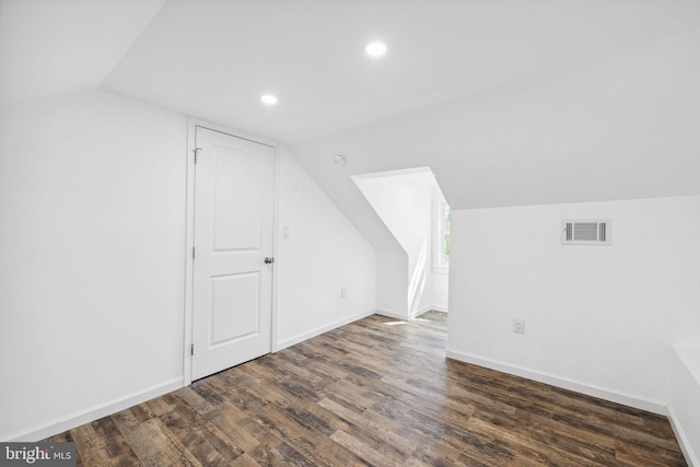 bonus room with dark hardwood / wood-style floors and lofted ceiling