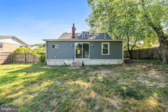 back of house featuring a yard