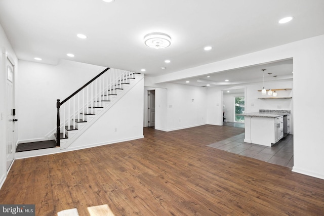 unfurnished living room with dark hardwood / wood-style floors