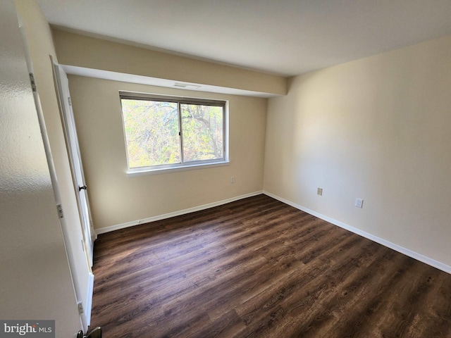 empty room featuring dark hardwood / wood-style flooring