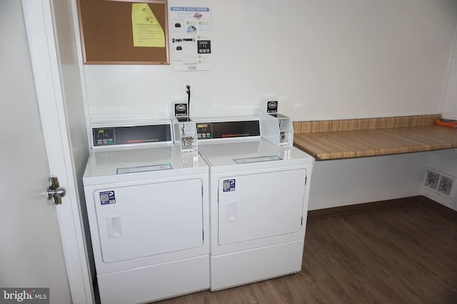 laundry room with dark hardwood / wood-style flooring and washer and clothes dryer