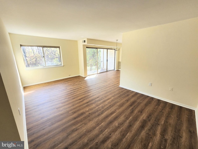 spare room featuring dark wood-type flooring