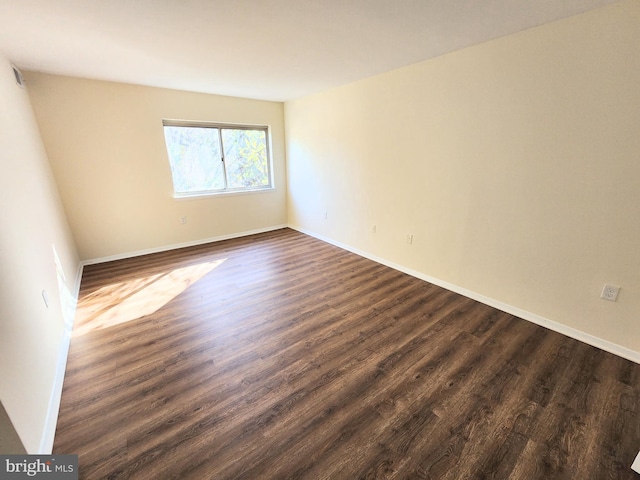 empty room featuring dark hardwood / wood-style floors