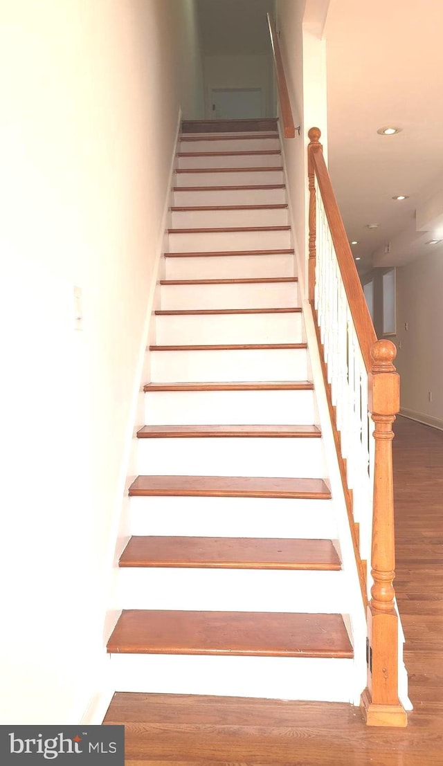 staircase featuring wood-type flooring