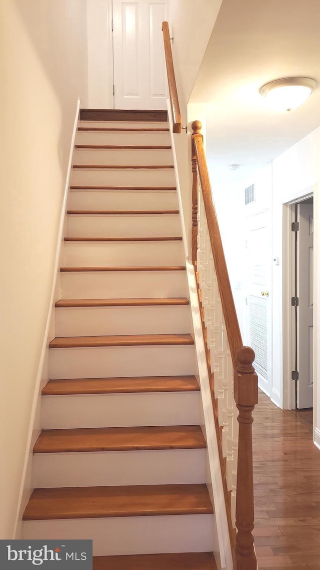 staircase featuring hardwood / wood-style flooring