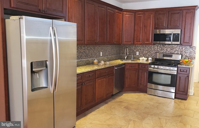 kitchen with decorative backsplash, light stone countertops, sink, and stainless steel appliances