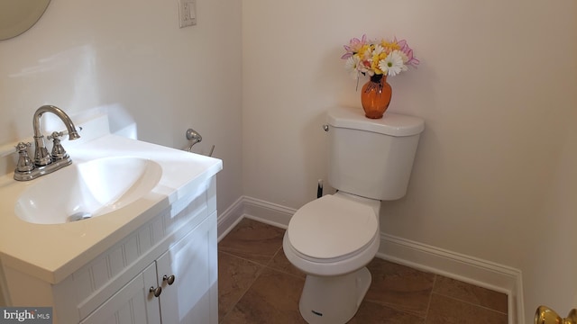 bathroom featuring tile patterned flooring, vanity, and toilet