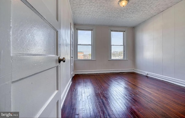 spare room with hardwood / wood-style flooring