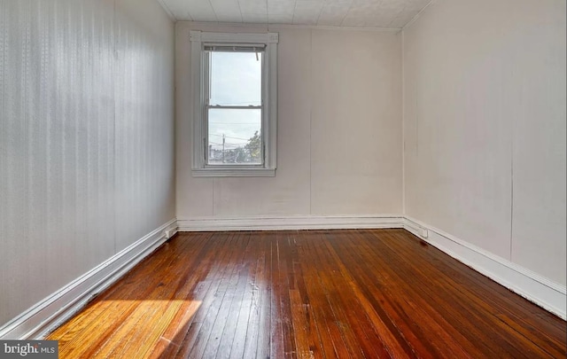 unfurnished room featuring dark wood-type flooring