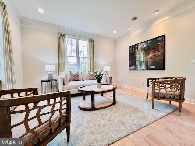 living room featuring ornamental molding and light hardwood / wood-style floors