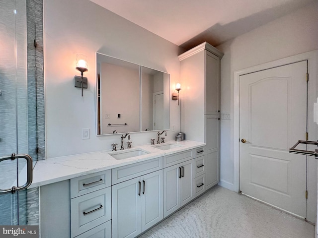 bathroom featuring a shower with door and vanity