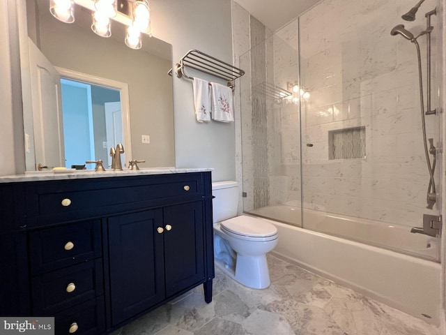 full bathroom with toilet, vanity, and tiled shower / bath combo