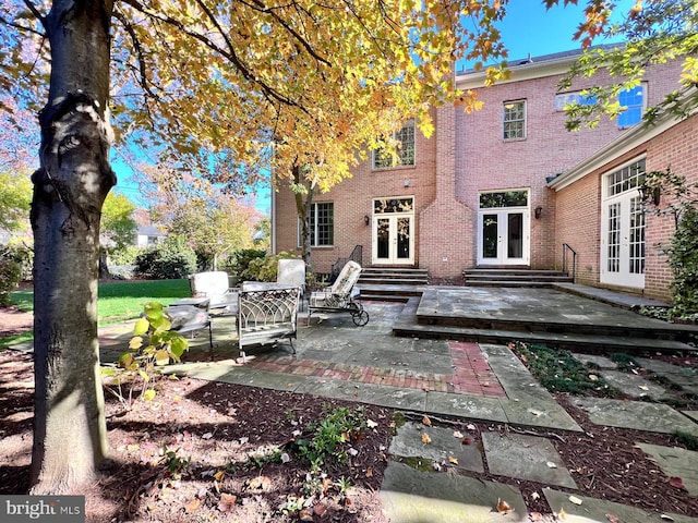 rear view of house featuring an outdoor hangout area, a patio, and french doors