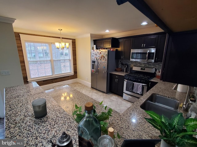 kitchen with light stone countertops, crown molding, a notable chandelier, and appliances with stainless steel finishes